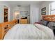 Bright bedroom featuring a wood frame bed, ensuite bathroom access, and neutral paint at 1326 Moss Dr, Dunedin, FL 34698