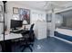 Bright bedroom featuring a desk, chair, and bed nook with painted floors, perfect for study and relaxation at 1326 Moss Dr, Dunedin, FL 34698