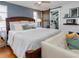 Comfortable bedroom with a king bed, a couch and barn door leading into the office space at 1326 Moss Dr, Dunedin, FL 34698