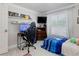 This cozy bedroom features a workspace and a comfortable bed, perfect for relaxation and productivity at 1326 Moss Dr, Dunedin, FL 34698