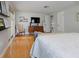 Open and airy bedroom with hardwood floors and a comfortable chair near the window with natural light at 1326 Moss Dr, Dunedin, FL 34698