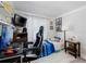 Comfortable bedroom featuring a desk, a television, and a bed, perfect for a relaxing and functional living space at 1326 Moss Dr, Dunedin, FL 34698