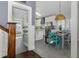 Open-concept dining area with views to a modern kitchen and lots of natural light at 1326 Moss Dr, Dunedin, FL 34698