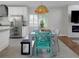 Open dining area with white cabinets and stainless steel appliances at 1326 Moss Dr, Dunedin, FL 34698
