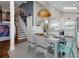 Bright dining room with a modern pendant light fixture and access to the kitchen at 1326 Moss Dr, Dunedin, FL 34698