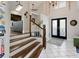 Spacious entryway with staircase and double door entry with tile flooring at 1326 Moss Dr, Dunedin, FL 34698