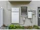 The exterior shows the Tesla power wall, electric meter, and a gray side door at 1326 Moss Dr, Dunedin, FL 34698