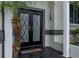 Close up of front double doors with a black tiled entry at 1326 Moss Dr, Dunedin, FL 34698
