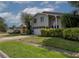 Charming two-story home with a two-car garage and well-manicured front yard at 1326 Moss Dr, Dunedin, FL 34698