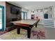 Fun game room with a ping pong table, fireplace, TV, and direct access to the outdoors at 1326 Moss Dr, Dunedin, FL 34698