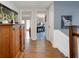 Hallway featuring hardwood floors, cabinet, and doorways to living areas at 1326 Moss Dr, Dunedin, FL 34698
