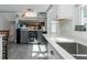 Bright kitchen featuring a stainless steel beverage cooler, ample counter space, and convenient storage solutions at 1326 Moss Dr, Dunedin, FL 34698