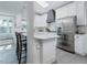 Modern kitchen featuring white cabinets, stainless steel appliances, and a breakfast bar at 1326 Moss Dr, Dunedin, FL 34698