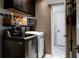 Functional laundry room featuring modern washer and dryer with storage at 1326 Moss Dr, Dunedin, FL 34698