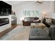 Comfortable living room featuring hardwood floors, a modern fireplace, and comfortable seating at 1326 Moss Dr, Dunedin, FL 34698