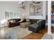 Bright living room with hardwood floors, large windows, and comfortable seating at 1326 Moss Dr, Dunedin, FL 34698