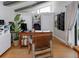 Bright home office with hardwood floors, a desk, bookshelves, a plant, a large window, and a chair at 1326 Moss Dr, Dunedin, FL 34698