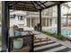 The cozy outdoor seating area sits alongside a sparkling pool and manicured landscaping at 1326 Moss Dr, Dunedin, FL 34698