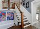 Staircase featuring wood steps, white risers, and an open railing design at 1326 Moss Dr, Dunedin, FL 34698