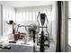 A bright workout room featuring white walls and many pieces of workout equipment at 1326 Moss Dr, Dunedin, FL 34698