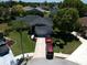 Aerial shot of a home showcasing its well-maintained lawn, landscaping, driveway and surrounding neighborhood at 14324 Bronte Ct, Hudson, FL 34667