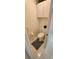 Small half bathroom with white fixtures and a built-in cabinet for storing toiletries at 14324 Bronte Ct, Hudson, FL 34667