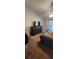 Bedroom featuring a dark dresser with TV, ceiling fan, and neutral carpeting at 14324 Bronte Ct, Hudson, FL 34667