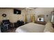 Comfortable bedroom features a ceiling fan, TV, office space, and dresser with a mirror at 14324 Bronte Ct, Hudson, FL 34667