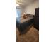 Bedroom featuring a queen bed with dark bedding and a stuffed lion resting on top at 14324 Bronte Ct, Hudson, FL 34667
