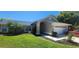 Well-maintained home featuring a two-car garage, manicured lawn, and lush landscaping at 14324 Bronte Ct, Hudson, FL 34667