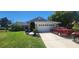 Charming single-story home boasts a manicured lawn, a two-car garage, and vehicles at 14324 Bronte Ct, Hudson, FL 34667