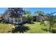 Landscaped front yard showcasing lush green grass, well-placed trees, and manicured garden beds at 14324 Bronte Ct, Hudson, FL 34667