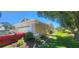 Side view of the house featuring an attached garage, neatly maintained landscaping, and a car in the driveway at 14324 Bronte Ct, Hudson, FL 34667