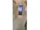 Hallway view featuring a glimpse of a bedroom and tiled flooring at 14324 Bronte Ct, Hudson, FL 34667