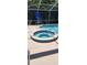 Relaxing hot tub with tile surround, perfect for unwinding after a long day at 14324 Bronte Ct, Hudson, FL 34667