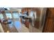 Well-lit kitchen featuring stainless steel appliances, tile flooring, and granite countertops at 14324 Bronte Ct, Hudson, FL 34667