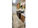 Functional laundry room with modern black washer and dryer, ample counter space, and wooden cabinets at 14324 Bronte Ct, Hudson, FL 34667