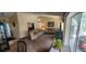 Spacious living room leading to a screened lanai and pool area at 14324 Bronte Ct, Hudson, FL 34667