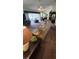 View of the carpeted living room with ceiling fan, and sitting area visible through the sliding glass doors at 14324 Bronte Ct, Hudson, FL 34667