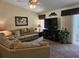 Living room showcasing a comfortable sectional sofa and a modern electric fireplace at 14324 Bronte Ct, Hudson, FL 34667