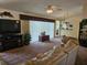 Comfortable living room with a large sectional sofa, entertainment center, and a view into the kitchen at 14324 Bronte Ct, Hudson, FL 34667