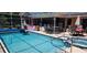 Inviting screened pool and spa with a bar and patio perfect for outdoor enjoyment and relaxation at 14324 Bronte Ct, Hudson, FL 34667