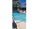 Refreshing screened pool surrounded by a white enclosure, with lush greenery adding privacy at 14324 Bronte Ct, Hudson, FL 34667