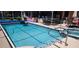 Sparkling screened pool with an attached spa, poolside bar, and inviting outdoor dining area at 14324 Bronte Ct, Hudson, FL 34667