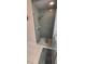 Walk-in shower featuring green tiling, a glass door and bright overhead lighting at 14324 Bronte Ct, Hudson, FL 34667