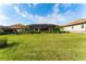 Spacious backyard featuring a screen-enclosed pool area and manicured lawn at 148 Mossy River Ct, Brandon, FL 33511