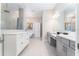 Elegant bathroom featuring dual vanities, a soaking tub, and a separate tiled shower at 148 Mossy River Ct, Brandon, FL 33511