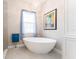 Spa-like bathroom with a freestanding tub, chandelier, and soft, natural light at 148 Mossy River Ct, Brandon, FL 33511