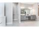 Bright bathroom with gray cabinets, dual sinks, and a separate door to the water closet at 148 Mossy River Ct, Brandon, FL 33511