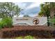 Elegant community entrance sign with stone accents and lush landscaping welcoming residents to The Sanctuary at 148 Mossy River Ct, Brandon, FL 33511